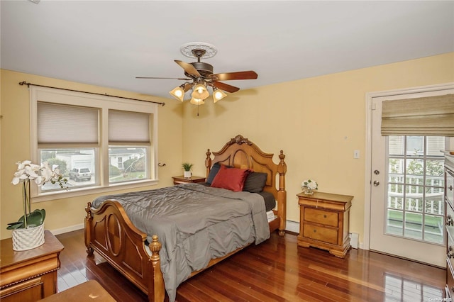 bedroom featuring access to exterior, ceiling fan, dark hardwood / wood-style flooring, and a baseboard radiator