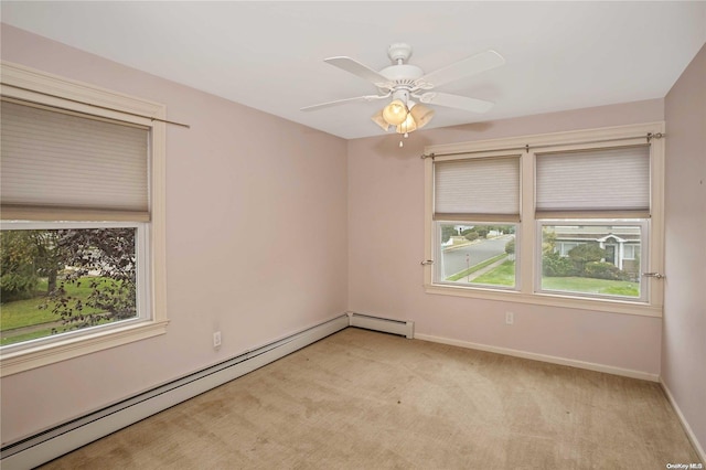 carpeted spare room featuring a baseboard radiator and ceiling fan