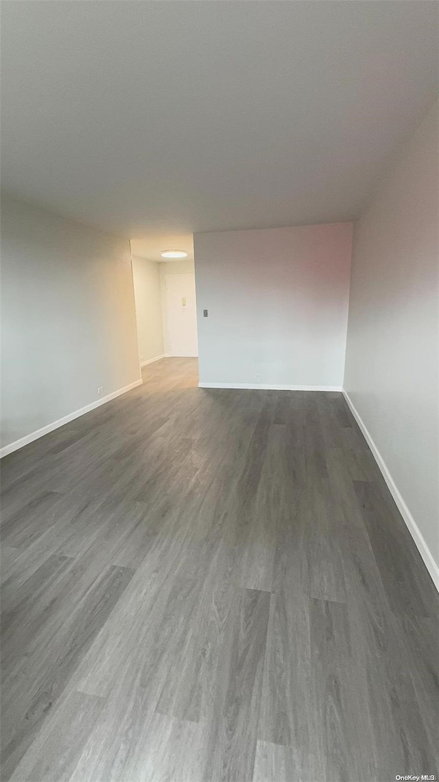 empty room with dark hardwood / wood-style floors