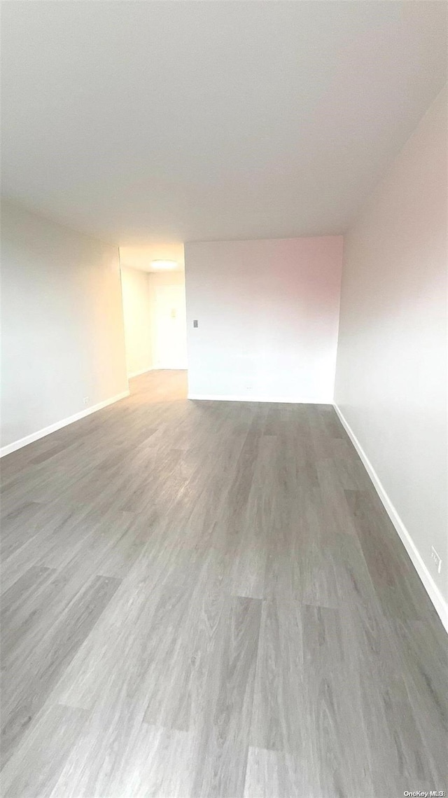 empty room with hardwood / wood-style flooring