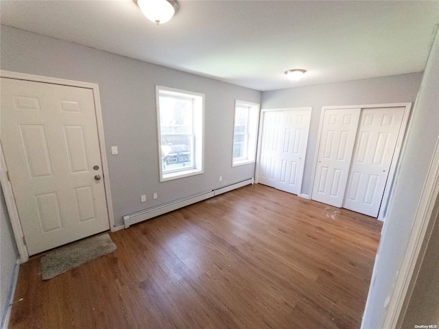 entryway with hardwood / wood-style flooring and a baseboard heating unit