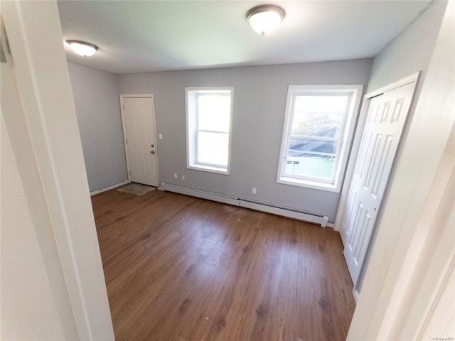 empty room with light hardwood / wood-style flooring and a baseboard radiator