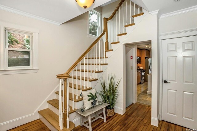 9 N Bayles Ave, Port Washington, NY 11050 - staircase with hardwood / wood-style floors and crown molding