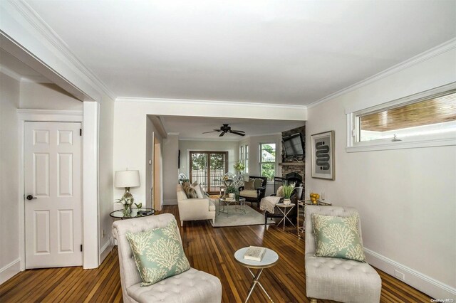 9 N Bayles Ave, Port Washington, NY 11050 - sitting room featuring dark hardwood / wood-style floors, a stone fireplace, ceiling fan, and crown molding
