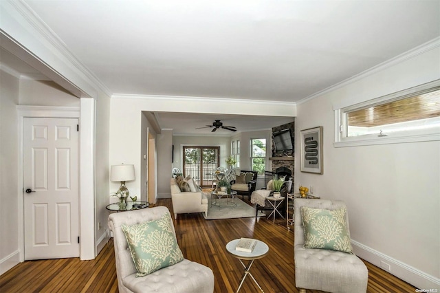9 N Bayles Ave, Port Washington, NY 11050 - living area with wood finished floors, crown molding, baseboards, and a stone fireplace