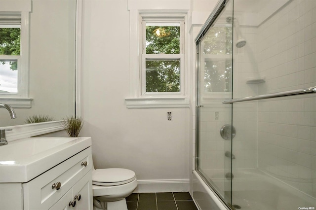 9 N Bayles Ave, Port Washington, NY 11050 - full bathroom featuring toilet, vanity, tile patterned floors, and bath / shower combo with glass door