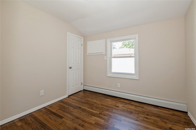 spare room featuring a baseboard radiator, vaulted ceiling, and dark wood-type flooring