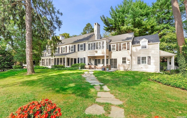 view of front facade featuring outdoor lounge area, a patio area, and a front lawn