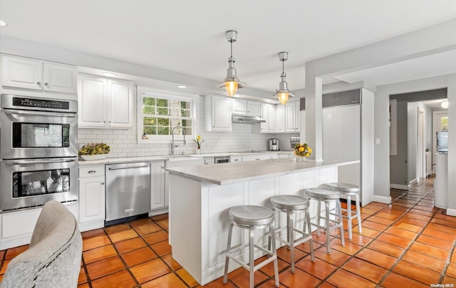 kitchen with white cabinets, sink, and appliances with stainless steel finishes