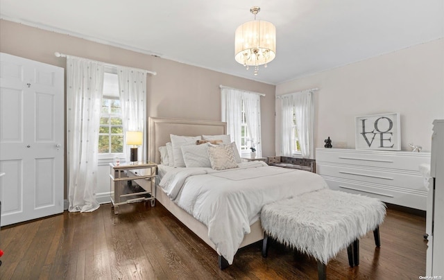 bedroom featuring dark hardwood / wood-style floors, a chandelier, and multiple windows