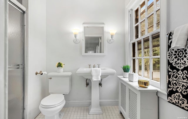 bathroom with toilet, tile patterned floors, and an enclosed shower