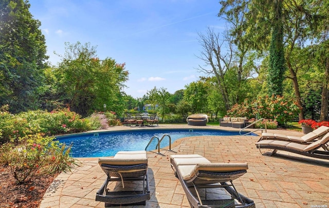 view of swimming pool with outdoor lounge area and a patio area