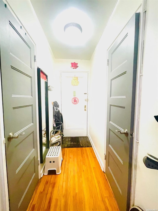 doorway with hardwood / wood-style flooring