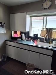 159-29 92nd St, Howard Beach, NY 11414 - kitchen featuring a sink and dark countertops