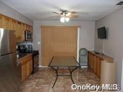 kitchen featuring ceiling fan and stainless steel appliances