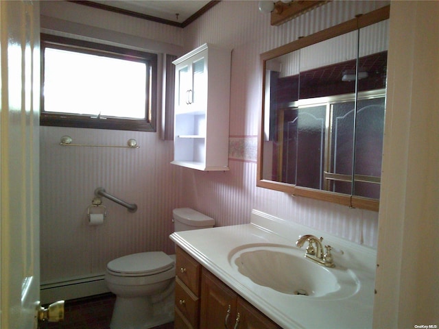 bathroom featuring vanity, a baseboard heating unit, and toilet