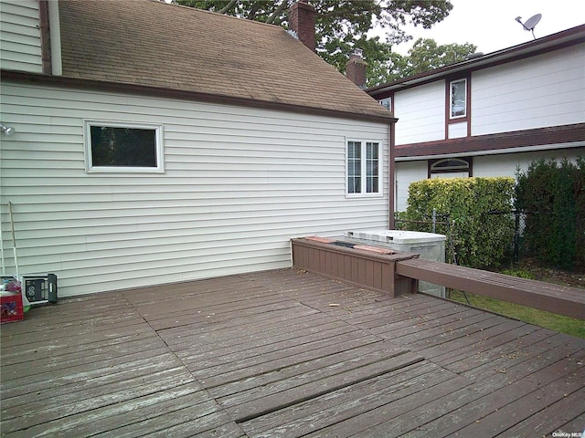 wooden terrace featuring a hot tub