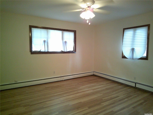 empty room featuring ceiling fan, plenty of natural light, and light hardwood / wood-style floors