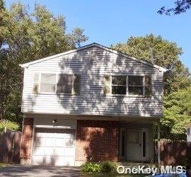 679A Meadow Rd, Smithtown, NY 11787 - view of front of house with a garage