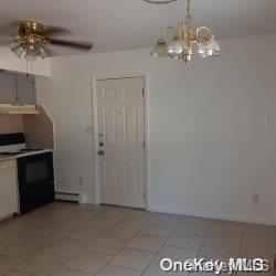 kitchen featuring dishwasher, ceiling fan with notable chandelier, electric range, white cabinetry, and extractor fan