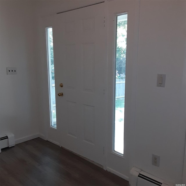 foyer featuring baseboard heating and dark wood-type flooring