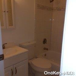 full bathroom featuring vanity, toilet, and tiled shower / bath