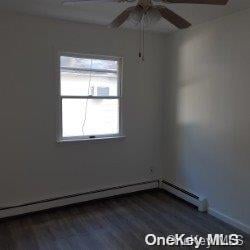 empty room featuring dark hardwood / wood-style flooring