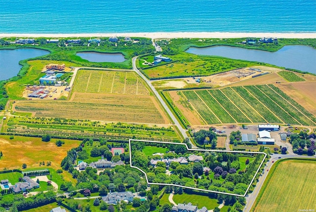 bird's eye view featuring a water view, a rural view, and a beach view