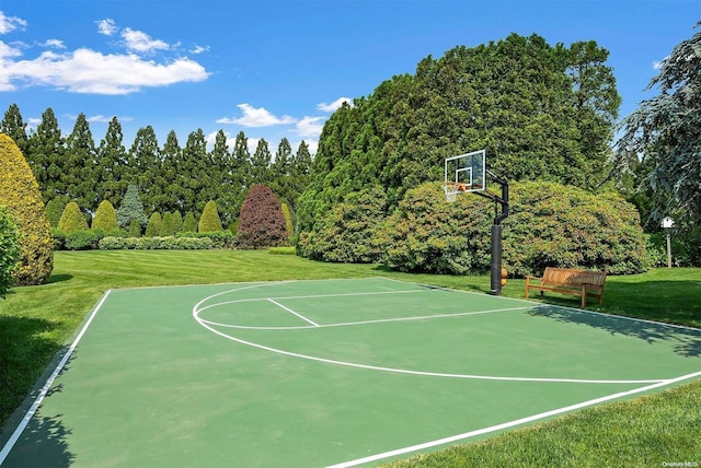 view of sport court with a yard