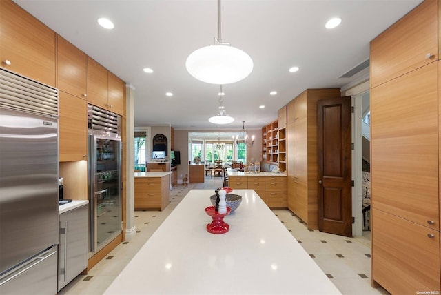 kitchen featuring stainless steel built in fridge, beverage cooler, pendant lighting, and a notable chandelier