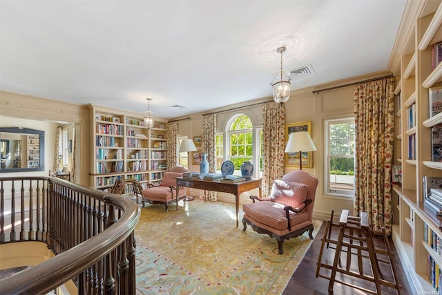 sitting room with crown molding, dark hardwood / wood-style flooring, and a notable chandelier