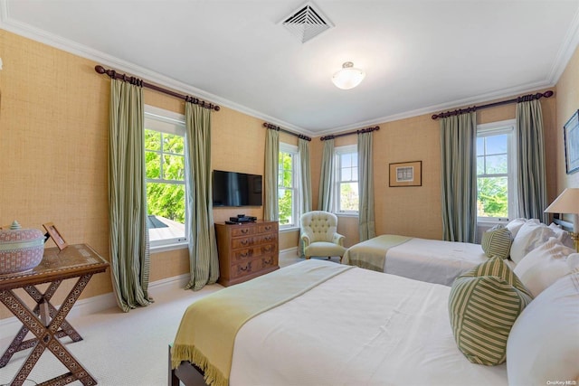 bedroom featuring carpet flooring, ornamental molding, and multiple windows