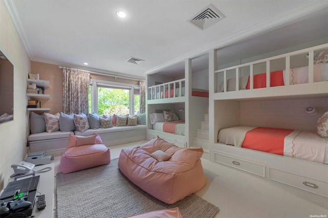 bedroom with ornamental molding and carpet floors