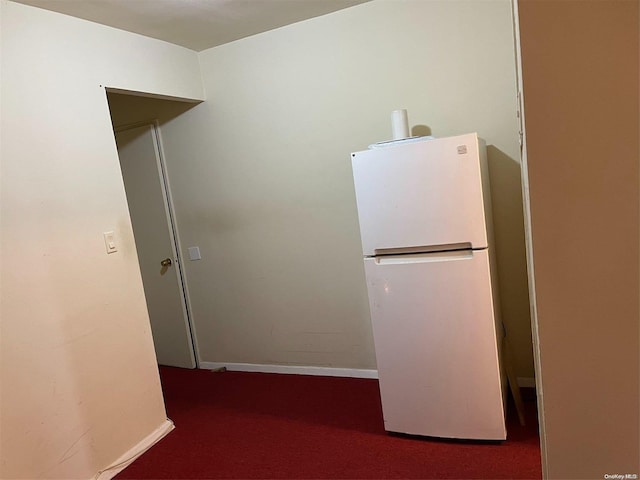 kitchen with carpet flooring and white refrigerator