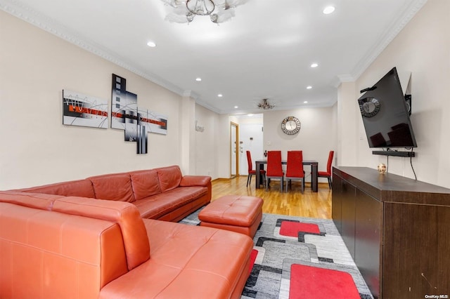 living room featuring light wood-type flooring and ornamental molding