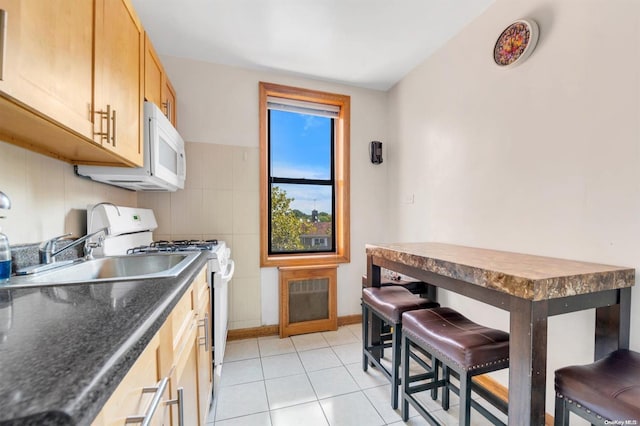 108-50 62nd Dr Unit 3F, Forest Hills, NY 11375 - kitchen featuring white appliances, dark countertops, and light tile patterned floors