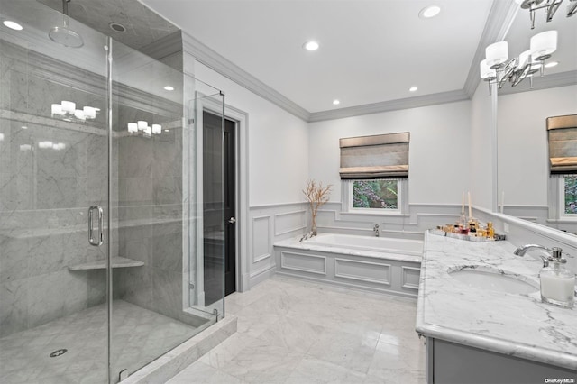 full bathroom featuring crown molding, wainscoting, a sink, and a decorative wall