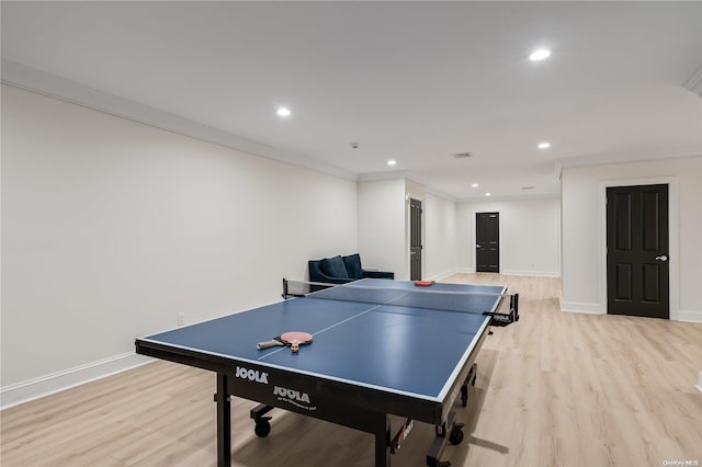 recreation room with light wood finished floors, baseboards, and ornamental molding