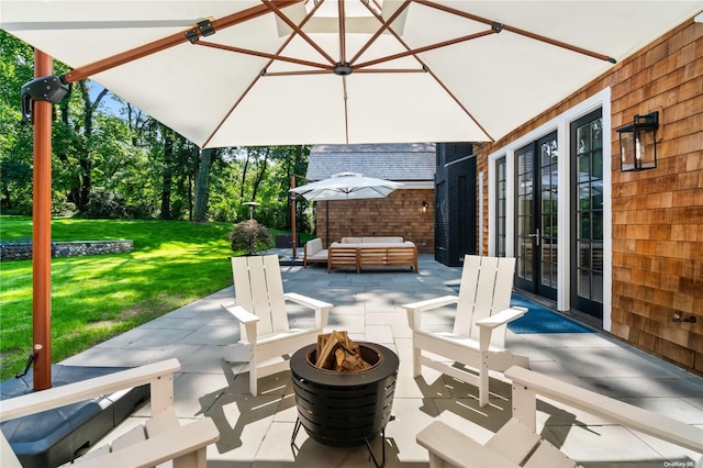 view of patio / terrace with an outdoor living space with a fire pit