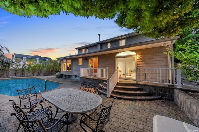 exterior space with a fenced in pool and a patio