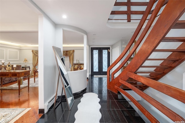 entryway featuring dark hardwood / wood-style flooring, french doors, and a baseboard radiator