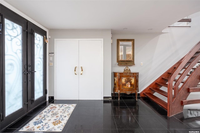 foyer with french doors and a healthy amount of sunlight