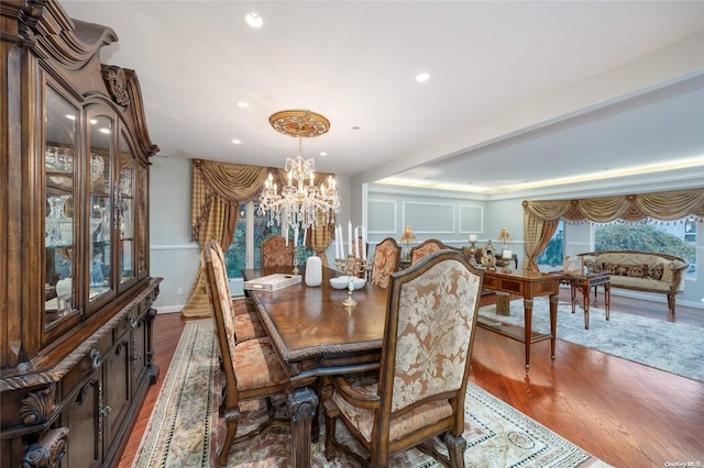 dining space with a chandelier and wood-type flooring