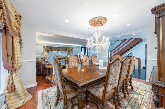 dining space with dark hardwood / wood-style flooring and a chandelier