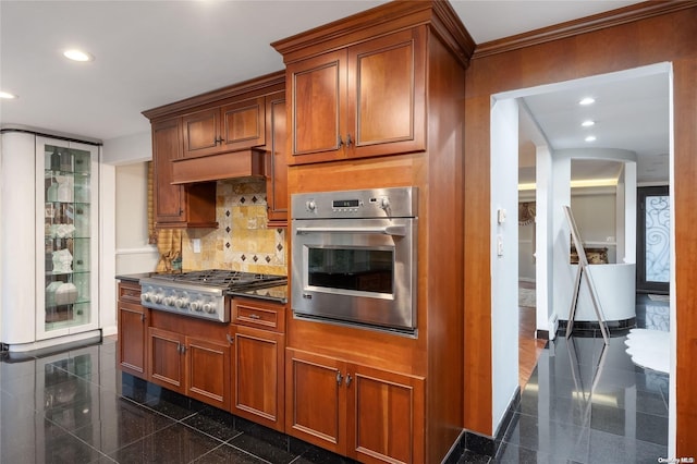 kitchen featuring crown molding, stainless steel appliances, and tasteful backsplash