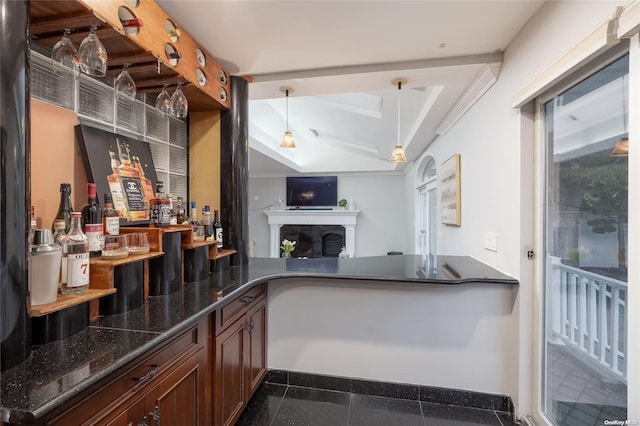 kitchen featuring pendant lighting and dark stone counters