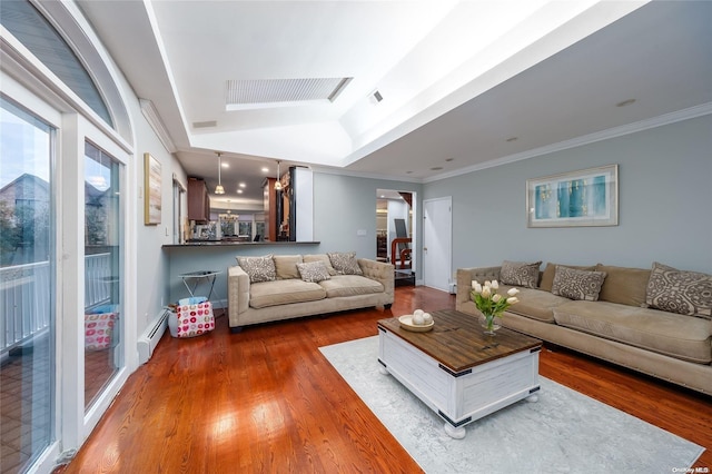 living room with dark hardwood / wood-style flooring, crown molding, and a baseboard heating unit