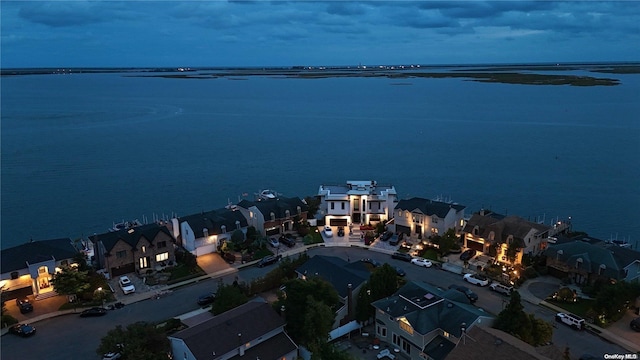 aerial view at dusk with a water view