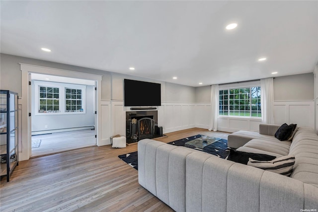 living room featuring light hardwood / wood-style floors and a baseboard radiator