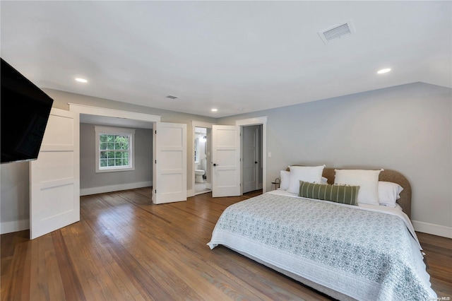 bedroom with dark hardwood / wood-style floors